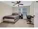 Bedroom with a comfortable bed, ceiling fan, and a functional desk setup at 235 Holly Nw Rd, Atlanta, GA 30314