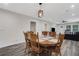 Open-concept dining room with wood table, seating for eight, and modern light fixture at 235 Holly Nw Rd, Atlanta, GA 30314