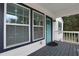 Close-up of the inviting front porch with a striking teal door and ample natural light at 235 Holly Nw Rd, Atlanta, GA 30314