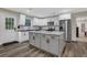 Well-lit kitchen featuring white cabinets, granite countertops, a large island, and stainless steel appliances at 235 Holly Nw Rd, Atlanta, GA 30314
