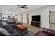 Open-concept living room flowing into the kitchen, featuring hardwood floors and a comfortable sectional sofa at 235 Holly Nw Rd, Atlanta, GA 30314