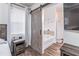 Bathroom view with white tub and tile surround, accessed by sliding barn door at 408 Blue Sky Cir, Acworth, GA 30102