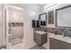 Modern bathroom featuring double sinks, gray vanities, mosaic tile accents, and a tiled shower with a glass door at 408 Blue Sky Cir, Acworth, GA 30102