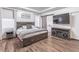Cozy bedroom with wood floors, decorative accent wall, and a large TV at 408 Blue Sky Cir, Acworth, GA 30102