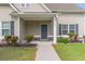 Inviting front porch with dark door, decorative wreath, manicured landscaping, and stone accents at 408 Blue Sky Cir, Acworth, GA 30102