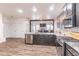 Modern kitchen with an island, stainless steel appliances, and a seamless open floor plan at 408 Blue Sky Cir, Acworth, GA 30102