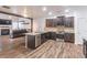 Open kitchen with stainless appliances, dark wood cabinets, granite countertops, and eat in area at 408 Blue Sky Cir, Acworth, GA 30102