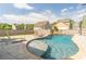Backyard swimming pool and stone patio with lounge chairs and privacy fence on a sunny day at 408 Blue Sky Cir, Acworth, GA 30102