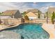 Backyard swimming pool with waterfall feature surrounded by patio, lounge chair, and privacy fence at 408 Blue Sky Cir, Acworth, GA 30102