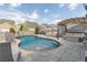 Backyard swimming pool with stone patio, lounge area with pergola, and privacy fence at 408 Blue Sky Cir, Acworth, GA 30102