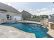 Inviting backyard pool and spa with patio area, surrounded by a wooden fence, and a view of the house at 408 Blue Sky Cir, Acworth, GA 30102