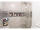 Large, tiled shower with rainfall showerhead, glass door, and built-in shelves for toiletries at 408 Blue Sky Cir, Acworth, GA 30102
