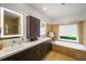 Bathroom with double sinks, bathtub, and large vanity with lots of cabinets at 4569 Fountain Ne Dr, Marietta, GA 30067