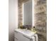 Stylish bathroom with a stone accent wall, floating vanity, and an illuminated mirror at 4569 Fountain Ne Dr, Marietta, GA 30067