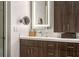 Elegant bathroom featuring a wood vanity with a stone countertop and a bright, lighted mirror at 4569 Fountain Ne Dr, Marietta, GA 30067
