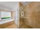 Bathroom featuring a glass shower and separate tub under a window at 4569 Fountain Ne Dr, Marietta, GA 30067
