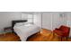 Bright bedroom with hardwood floors, natural light, and a cozy orange chair at 4569 Fountain Ne Dr, Marietta, GA 30067