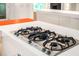 Island cooktop featuring black burners and stainless steel knobs at 4569 Fountain Ne Dr, Marietta, GA 30067