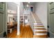 Inviting foyer showcasing hardwood floors, a staircase, and open sightlines to living and dining areas at 4569 Fountain Ne Dr, Marietta, GA 30067