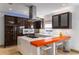 Kitchen island featuring a stovetop and bar seating, accented by zebra wood cabinetry at 4569 Fountain Ne Dr, Marietta, GA 30067