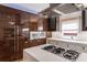 Modern kitchen showcasing zebra wood cabinets and a stainless-steel stovetop at 4569 Fountain Ne Dr, Marietta, GA 30067