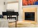 Close-up of a living room with a piano, fireplace, and modern carpet at 4569 Fountain Ne Dr, Marietta, GA 30067