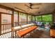 Spacious screened porch with ceiling fans, wood decking, and comfortable seating at 4569 Fountain Ne Dr, Marietta, GA 30067