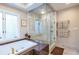 Beautiful bathroom featuring a soaking tub with gold fixtures, glass shower, and marble details at 1100 Parker Ne Pl, Atlanta, GA 30324