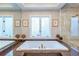 Elegant bathroom with a large soaking tub, dual windows, and decorative accents at 1100 Parker Ne Pl, Atlanta, GA 30324