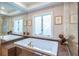 Elegant bathroom featuring soaking tub with beautiful accents and dual windows at 1100 Parker Ne Pl, Atlanta, GA 30324