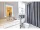 Elegant bathroom with a modern vanity, toilet, and framed mirror with a decorative shower curtain at 1100 Parker Ne Pl, Atlanta, GA 30324