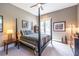 Comfortable bedroom with a four-poster bed, ceiling fan, and access to a private balcony with outdoor views at 1100 Parker Ne Pl, Atlanta, GA 30324