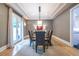 Elegant dining room with a glass table, modern chairs, and sophisticated lighting at 1100 Parker Ne Pl, Atlanta, GA 30324