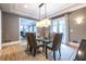This dining room features a glass-topped table, seating for six, and french doors to the backyard at 1100 Parker Ne Pl, Atlanta, GA 30324
