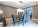 Dining room features a glass table, modern chairs, decorative lighting, and hardwood flooring at 1100 Parker Ne Pl, Atlanta, GA 30324