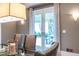 A closer view of the dining room with glass table, modern seating, and doors to the backyard at 1100 Parker Ne Pl, Atlanta, GA 30324