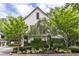Elegant home exterior featuring manicured landscaping, lush trees, a pedestrian gate, and architectural details at 1100 Parker Ne Pl, Atlanta, GA 30324