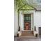 Home's exterior showcasing a grand entrance with a striking front door, complementary planters, and manicured greenery at 1100 Parker Ne Pl, Atlanta, GA 30324