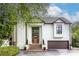 Stately home showcasing a tall front door, brick stairs, and manicured greenery, conveying a welcoming entrance at 1100 Parker Ne Pl, Atlanta, GA 30324