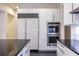 This kitchen has a built-in refrigerator, stainless steel ovens, and sleek white cabinets at 1100 Parker Ne Pl, Atlanta, GA 30324