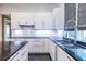 Modern kitchen boasts white cabinets, subway tile backsplash, and a stainless steel faucet at 1100 Parker Ne Pl, Atlanta, GA 30324