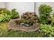 Charming water feature surrounded by lush plants and greenery, creating a tranquil and inviting outdoor space at 1100 Parker Ne Pl, Atlanta, GA 30324