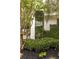 Landscaped pillar with house number and privacy wall featuring lush greenery and mulch beds at 1100 Parker Ne Pl, Atlanta, GA 30324