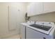 Modern laundry room equipped with a Samsung washer and dryer set, and white cabinets at 1100 Parker Ne Pl, Atlanta, GA 30324