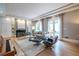 Elegant living room with a fireplace, shelving, modern furniture, and hardwood floors at 1100 Parker Ne Pl, Atlanta, GA 30324