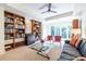 Bright living room showcasing bookcases, glass table, and natural light from the sliding glass doors at 1100 Parker Ne Pl, Atlanta, GA 30324