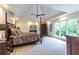 Bright main bedroom with a four-poster bed, dark wood furniture, and large windows offering natural light at 1100 Parker Ne Pl, Atlanta, GA 30324