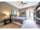 Main bedroom with neutral tones, a ceiling fan, balcony access, and built in shelving at 1100 Parker Ne Pl, Atlanta, GA 30324