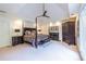 Elegant main bedroom featuring a four-poster bed, tray ceiling, and fireplace for a cozy retreat at 1100 Parker Ne Pl, Atlanta, GA 30324