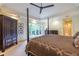 Spacious main bedroom featuring a four-poster bed, tray ceiling, and large windows offering ample natural light at 1100 Parker Ne Pl, Atlanta, GA 30324